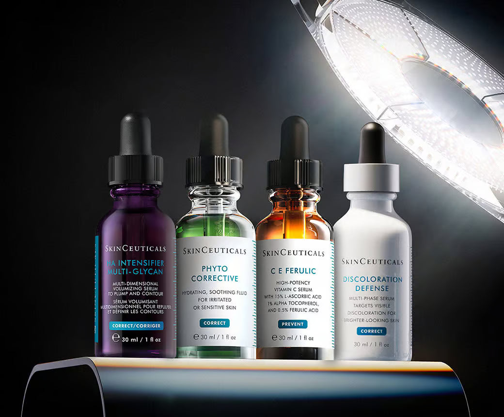 Four SkinCeuticals skincare bottles on a dark background with a spotlight effect.